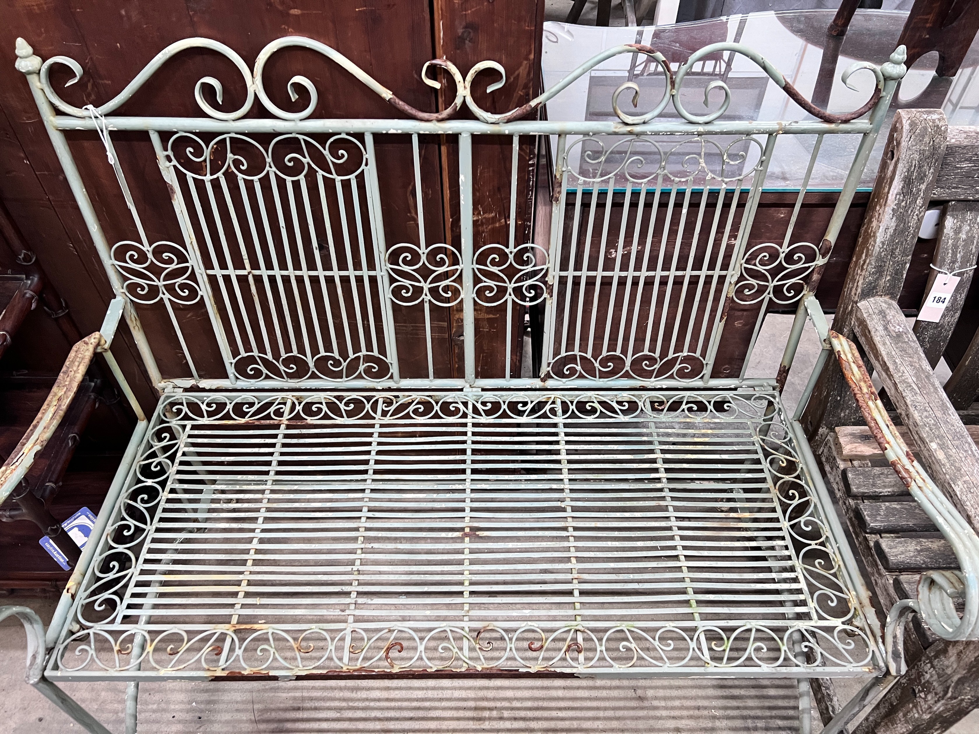 A painted wrought iron folding garden bench, width 108cm *Please note the sale commences at 9am.